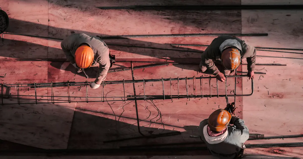 Construction Workers on Site - Professional Team with Orange Hard Hats Overseeing Construction Project